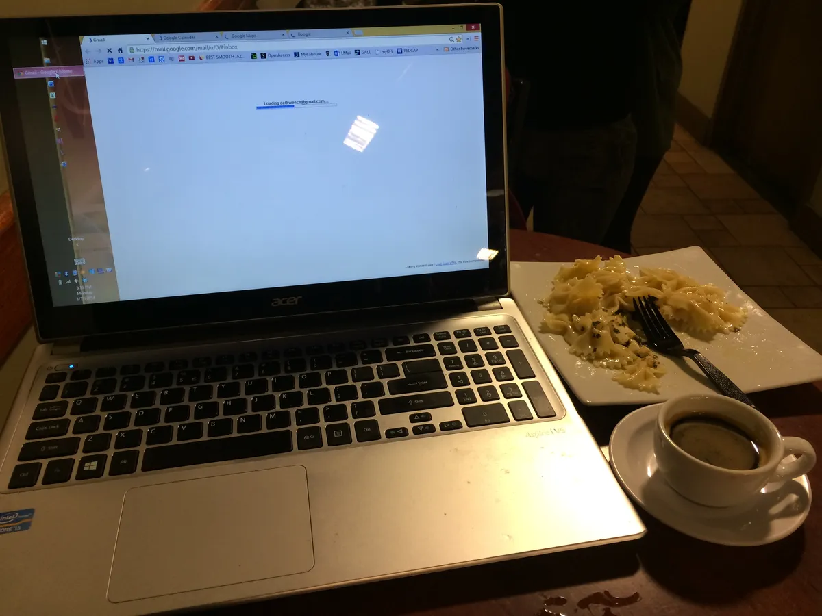 Digital nomad working on laptop at cafe